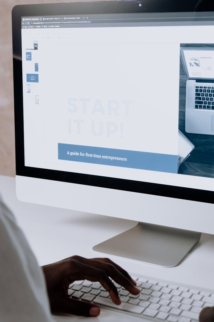 about-01 Person working on a website design for first-time entrepreneurs on a desktop computer.